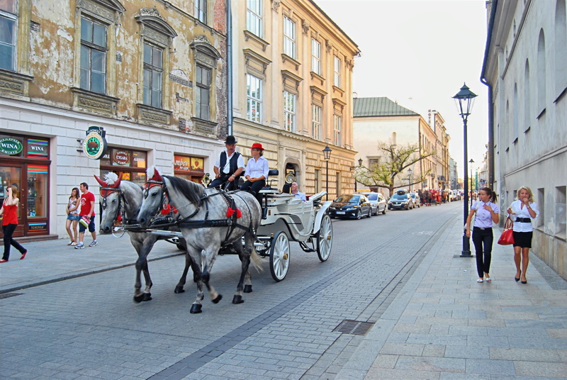1 - A traditional horse-drawn carriage ride along a historic street in the Old Town of Kraków, Poland